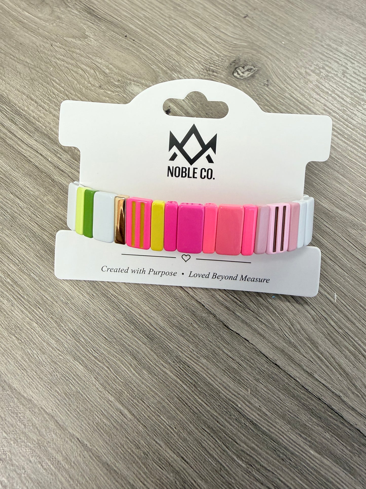 Capri Enamel Stretch Bracelet in Neon Pink by Noble Co. featuring colorful enamel tiles with gold-tone accents.