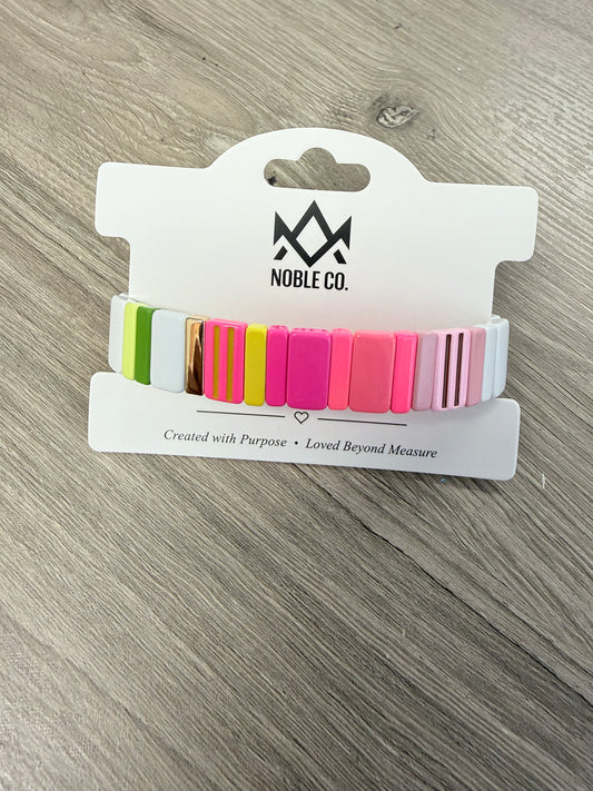 Capri Enamel Stretch Bracelet in Neon Pink by Noble Co. featuring colorful enamel tiles with gold-tone accents.