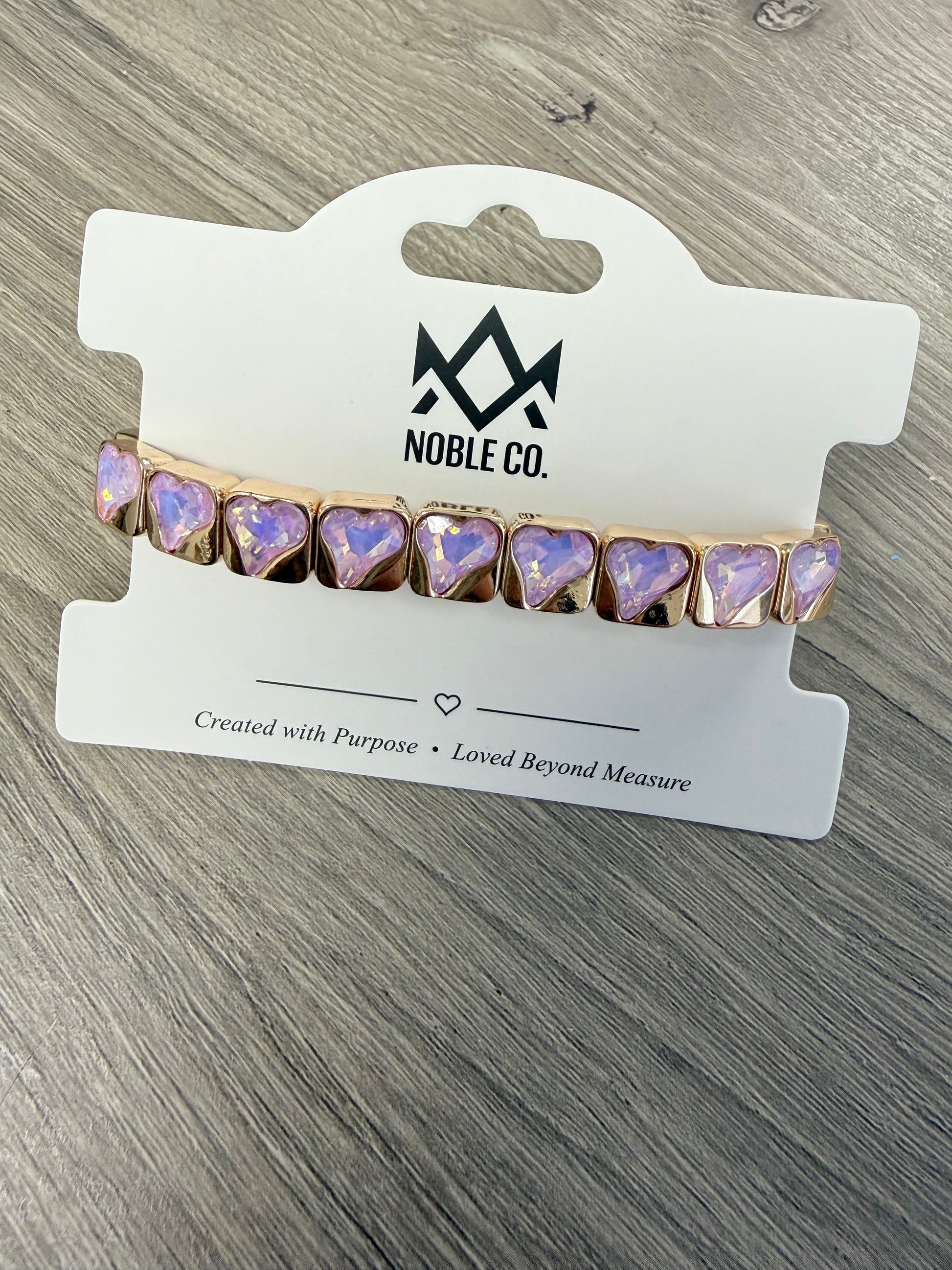 Everly Heart Crystal Stretch Bracelet in Lavender by Noble Co. featuring faceted heart-shaped crystals with polished gold-tone settings.