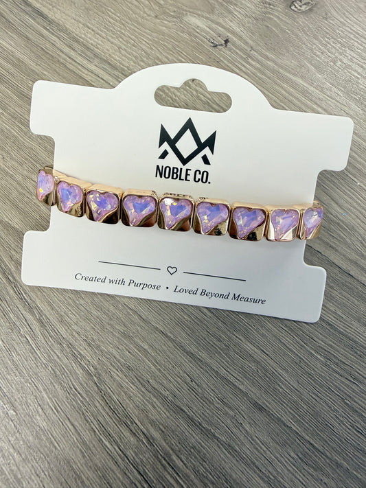 Everly Heart Crystal Stretch Bracelet in Lavender by Noble Co. featuring faceted heart-shaped crystals with polished gold-tone settings.